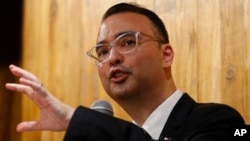 Philippine Foreign Affairs Secretary Alan Peter Cayetano gestures during a news conference on the South China Sea on Tuesday, Aug. 7, 2018, in suburban Taguig city east of Manila, Philippines. (AP Photo/Bullit Marquez)