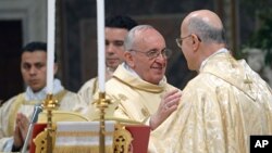 Pope Francis greets Secretary of State cardinal Tarcisio Bertone (r) as he celebrates his inaugural Mass with cardinals, inside the Sistine Chapel, at the Vatican, March 14, 2013. 