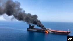 An oil tanker is on fire in the sea of Oman, Thursday, June 13, 2019. The incidents happened one month after four ships were damaged in the area, raising tensions between the United States and Iran. (AP Photo/ISNA)