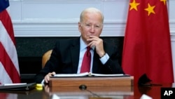 FILE - President Joe Biden listens as he meets virtually with Chinese President Xi Jinping from the Roosevelt Room of the White House in Washington, Nov. 15, 2021.