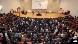 Iraqi lawmakers attend the parliament session in Baghdad, Iraq, Thursday, Nov. 11, 2010