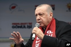 FILE - Turkey's President Recep Tayyip Erdogan addresses supporters of his ruling Justice and Development Party (AKP), during a rally in Gaziantep, Turkey, March 15, 2019.