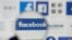 FILE - Facebook logos are seen on a screen in this picture illustration