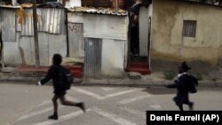 Children run to school in Alexandra township in Johannesburg, South Africa. Twenty-five years after the end of apartheid, inequality is still on display in South Africa.