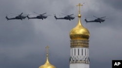Russian military helicopters fly over the Ivan the Great bell-tower and Kremlin during a rehearsal in Moscow, Russia, May 5, 2016.