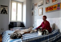 Francesca Valagussa, 40, plays with her pets at home, in Rome, Italy, March 16, 2020 during lockdown.