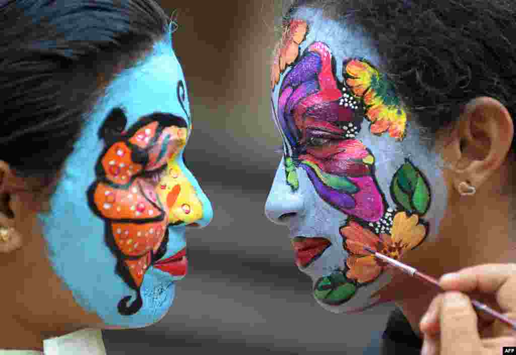 Indian nursing students participate in a face painting competition with the theme of 'Preserving the Nature' at Vijay Marie College of Nursing in Hyderabad on the occasion of the country's upcoming Independence Day celebrations.