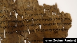 A fragment from the Dead Sea Scrolls that underwent genetic sampling to shed light on the 2,000-year-old biblical trove is shown to Reuters at the Israel Antiquities Authority (IAA) laboratory in Jerusalem June 2, 2020. (REUTERS/Ronen Zvulun)