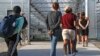 FILE - Suspects are led away to be processed during an immigration sting at Corso's Flower and Garden Center in Castalia, Ohio, June 5, 2018. 