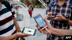 Iranians play Pokemon Go in northern Tehran's Mellat Park, Aug. 3, 2016. Iran was quick to ban the global gaming craze but as with many of the Islamic republic's internet controls, tech-savvy youngsters have carried on regardless.