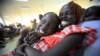 South Sudanese waiting to be flown back to their country sit at Khartoum Airport May 14, 2012. 