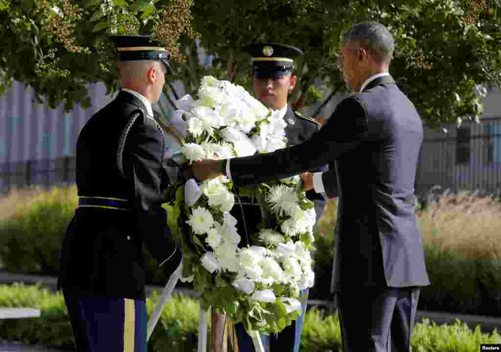 President Barack Obama places a wreath during a ceremony marking the 15th anniversary of the 9/11 attacks at the Pentagon in Washington, Sept. 11, 2016.