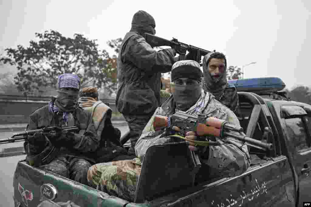 Taliban fighters patrol along a street during a demonstration by people to condemn the recent protest by the Afghan women&#39;s rights activists, in Kabul.