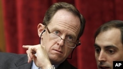 Supercommittee member, Sen. Patrick Toomey, R-Pa., left, confers with an aide, on Capitol Hill, Sept. 22, 2011.