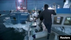 French and British fishing boats collide during a scrap in English Channel over scallop fishing rights, Aug. 28, 2018, in this still image taken from a video.