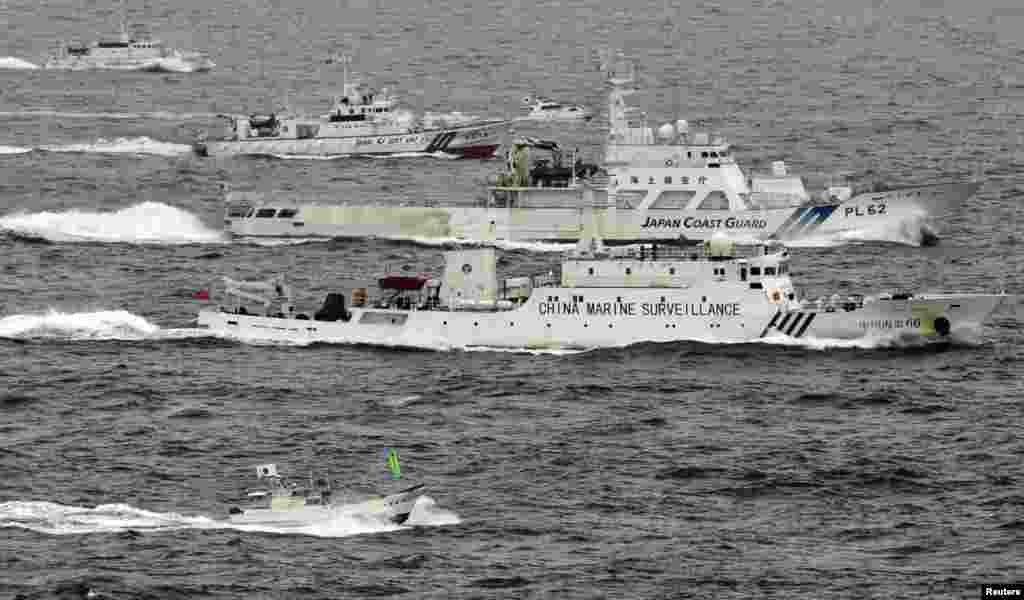 An aerial photo shows a Chinese marine surveillance ship Haijian No. 66 (C) cruising next to Japan Coast Guard patrol ships in the East China Sea, near islandes known as Senkaku in Japan and Diaoyu in China, in this photo taken by Kyodo.
