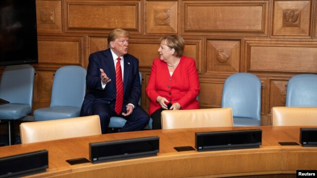 U.S. President Donald Trump talks to German Chancellor Angela Merkel at the U.N. headquarters in New York City, New York, U.S.,