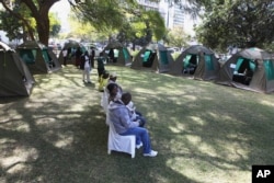 FILE - Members of the public wait to be tested for HIV and AIDS in Harare, Zimbabwe, June, 22, 2012.