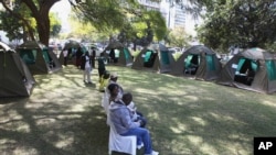 FILE: Members of the public wait to be tested for HIV and AIDS in Harare, Zimbabwe Friday June, 22, 2012. 