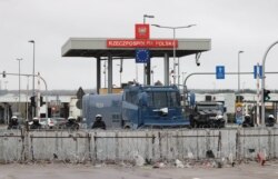 Polish law enforcement officers secure the frontier at the Bruzgi-Kuznica border crossing on the Belarusian-Polish border, Nov. 19, 2021.