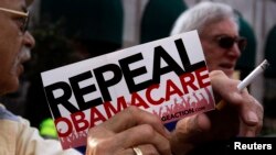FILE - A small group of demonstrators denouncing Obamacare rally in Indianapolis, Indiana, August 26, 2013. On Thursday, Republican lawmakers scored a symbolic victory in their quest to repeal the health care law but prospects of replacing it altogether remain far from certain.
