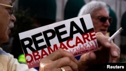 FILE - Demonstrators in Indianapolis, Indiana, denounce Obamacare, Aug. 26, 2013.