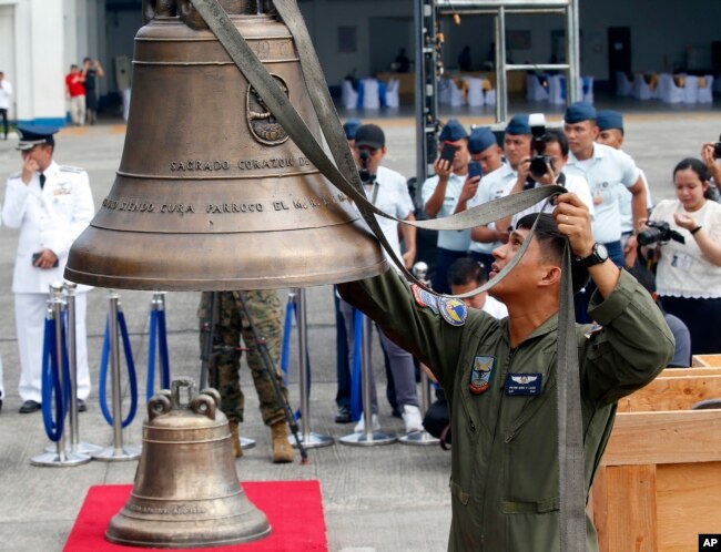 Philippine Air Force personnel unload three church bells seized by American troops as war trophies more than a century ago, as they arrive in suburban Pasay city southeast of Manila, Philippines, Dec. 11, 2018.