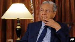 Malaysia's Prime Minister Mahathir Mohamad listens during an interview with The Associated Press in Putrajaya, Malaysia, Aug. 13, 2018. 