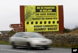 FILE - A car crosses over the border from the Irish Republic into Northern Ireland near the town of Jonesborough, Northern Ireland, Jan. 30, 2017. After Britain leaves the EU in 2019, the 500-kilometer (310-mile) border between Northern Ireland and Ireland will be the U.K.'s only land frontier with a member of the bloc.