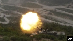 A South Korean army K1A1 tank fires during South Korea-U.S. joint military live-fire drills at Seungjin Fire Training Field in Pocheon, near the border with North Korea, June 22, 2012.