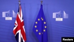 British and EU flags are seen before Britain's Prime Minister Theresa May meets with Commission President Jean-Claude Juncker to discuss draft agreements on Brexit, at the EC headquarters in Brussels, Belgium, Nov. 21, 2018. 
