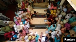 Relatives of seventeen children who died after a gas cylinder exploded on a school bus, mourn over their coffins, on the outskirts of Gujrat, 100 miles (170 km) southeast of Islamabad, May 25, 2013. The children were on their way to school when the incide