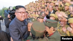 North Korean leader Kim Jong Un meets participants of the 5th National Conference of War Veterans in this undated photo released by North Korea's Korean Central News Agency (KCNA) on July 27, 2018.