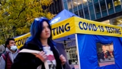 Pedestrians pass a COVID-19 testing tent on 42nd Street, Dec. 2, 2021, in the Manhattan borough of New York.