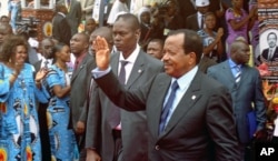 FILE - Cameroon's President Paul Biya waves to supporters during the opening of his party conference, in Yaounde, Sept. 15, 2011.