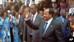 Cameroon's President Paul Biya waves to supporters during the opening of his party conference, in Yaounde, on September 15, 2011.
