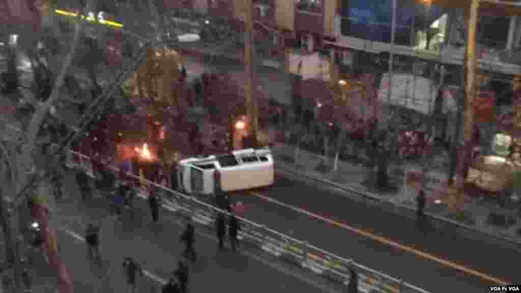 Protesters in Tehran's Valiasr avenue overturned a police car.