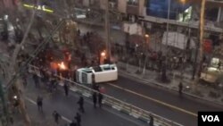 Protesters in Tehran's Valiasr avenue overturned a police car.