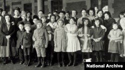 FILE - Immigrant children are part of this group photographed at Ellis Island in New York, about 1908.