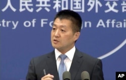 Lu Kang, spokesman of the Chinese Ministry of Foreign Affairs, speaks to reporters about the international tribunal's ruling on the South China Sea during a news briefing in Beijing, July 12, 2016.