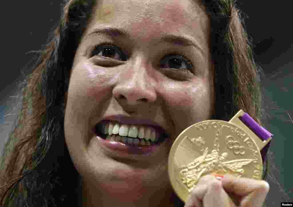 Ranomi Kromowidjojo of the Netherlands holds her gold medal during the women's 100m freestyle victory ceremony at the London 2012 Olympic Games at the Aquatics Centre August 2, 2012.