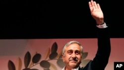 Newly-elected Turkish Cypriot leader Mustafa Akinci waves to supporters in Nicosia April 26, 2015. 