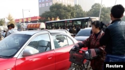 People look at the scene after explosions outside the Shanxi Provincial Communist Party office building in Taiyuan, Shanxi province, Nov. 6, 2013.