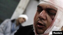 FILE - Protesters wounded during clashes with Egyptian riot police near Tahrir Square in Cairo.