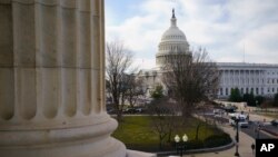 The Capitol is seen as defense arguments by the Republicans resume in the impeachment trial of President Donald Trump on charges of abuse of power and obstruction of Congress, in Washington, Monday, Jan. 27, 2020. (AP Photo/J. Scott Applewhite)