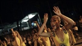 In this Jan. 27, 2020 photo, Rie Tankana dances during a rehearsal of the Paraiso do Tuiuti samba school in Rio de Janeiro, Brazil. (AP Photo/Silvia Izquierdo)