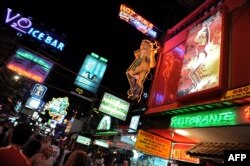 FILE - People walk in the red light district in Pattaya, Thailand, April 10, 2009. At the time, the U.S. put Thailand on its human trafficking watch list, accusing it of not doing enough to combat trafficking.