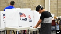 Devin Asbell fills out his primary election ballot at MetraPark Arena in Billings, Mont., June 5, 2018.