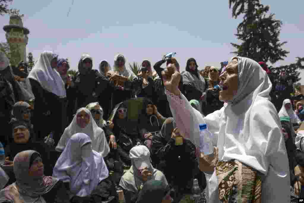 Palestinian women chant slogans prior to prayers at the Damascus Gate in Jerusalem, Israel.