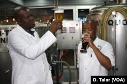 Chief brewer Phumelelo Marali (left) and his trainee Sibusiso Khumalo check the quality of some of their beer inside Africa's first airport-based brewery at O.R. Tambo International, near Johannesburg, South Africa.